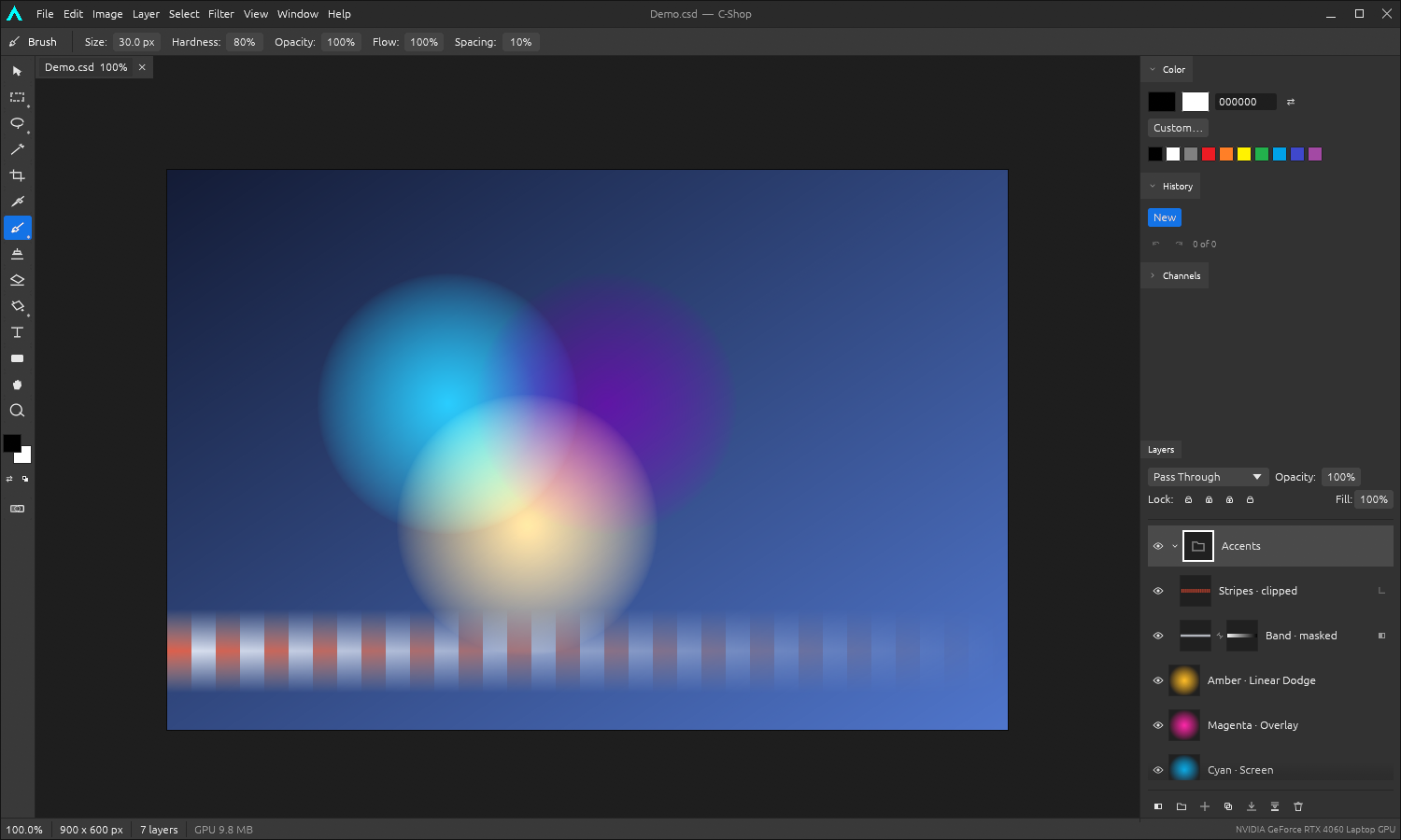 The C-Shop editor: a dark desktop interface with a tool palette down the left, brush options along the top, a demo document of overlapping cyan, magenta and amber glows on the canvas, and colour, history, channels and layers panels docked on the right.